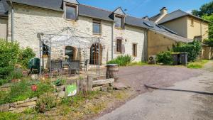 a house with a garden in front of it at Gîte La Longère in Laillé