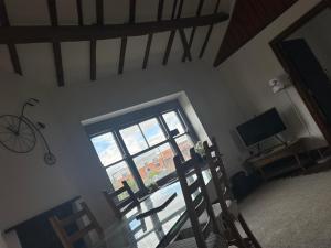 a room with a window and a table and chairs at The Upper Nest in Hereford