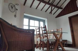 a dining room with a glass table and chairs at The Upper Nest in Hereford