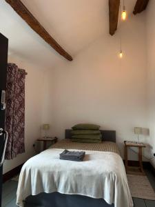 a bedroom with a bed with a white bedspread at The Upper Nest in Hereford