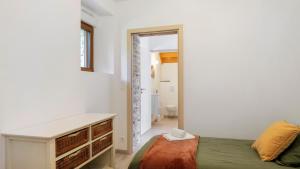 a bedroom with a bed and a desk and a bathroom at Gîte La Longère in Laillé +29 photos