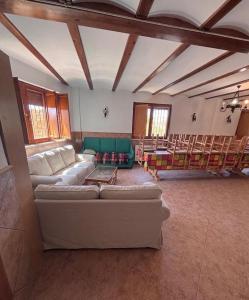 a large living room with a couch and chairs at Casa Familiar Mazalvete in Mazalvete