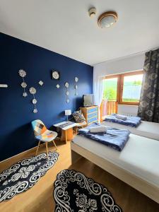 a bedroom with two beds and a blue wall at Nova Szymusiowa in Szczyrk +52 photos