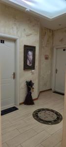 a room with two doors and a vase of flowers at Lille France Apartments in Shkodër