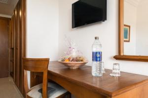 a bottle of water sitting on top of a wooden table at Yadis Hammamet in Hammamet