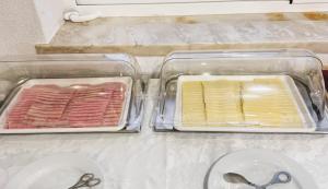 two plastic containers filled with different types of meat and scissors at B&B Berlenga 4 in Nazaré