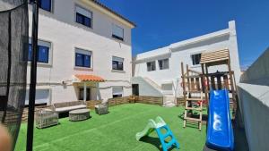 a backyard with a play yard with a playground at Meu Sonho Cascais - Praia in Alcabideche