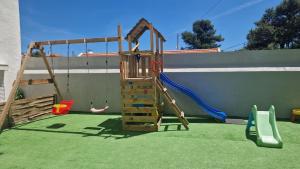 a playground with a ladder and a swing at Meu Sonho Cascais - Praia in Alcabideche