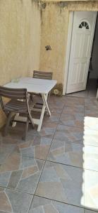 a white table and chairs in front of a door at Maisonette bedogao in Valence +4 photos