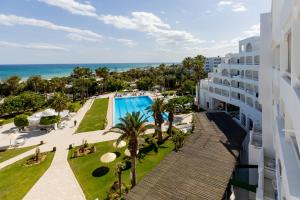an aerial view of a resort with a swimming pool and the ocean at Yadis Hammamet in Hammamet