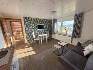 a living room with a couch and a table at Pension Haus Astenblick in Winterberg