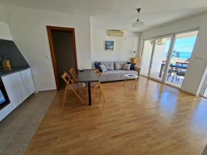a living room with a couch and a table at Sea View Apartments in Selca