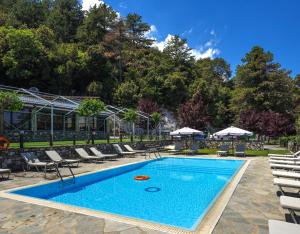 a swimming pool with lounge chairs and a resort at Ktima Faki, The One & Only Destination on Mount Olympus in Litochoro