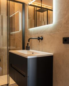 a bathroom with a sink and a mirror at Daga Resort in Zambrone