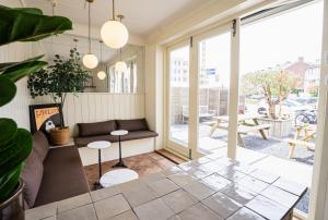 a living room with a couch and a table at Hotel Nine in Zandvoort