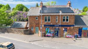 an old brick building on the corner of a street at Culzean Road, Retreat in Maybole