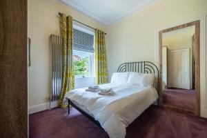 a bedroom with a bed and a window at Culzean Road, Retreat in Maybole