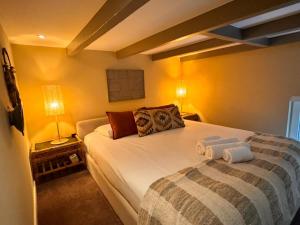 a bedroom with a bed with two towels on it at New monumental garden view Studio in Amsterdam