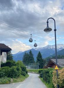 a street light with ski lifts in the mountains at Villa Fleurettes STUDIO in Le Châble +10 photos