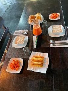 a wooden table with plates of food on it at Tambopata Haven lodge in Puerto Maldonado