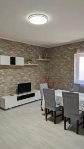 a living room with a television and a table and chairs at Casa Enza in Forio d'Ischia