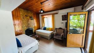 a room with a bedroom with a bed and a fireplace at Tomsan Villas Akyaka in Akyaka +100 photos