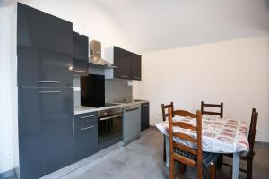 a kitchen with a table and a table and chairs at Gîte Maison de pêcheur in Le Crotoy