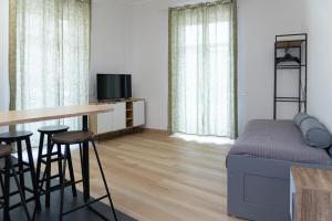 a bedroom with a bed and a table and stools at Salerno Stay in Salerno