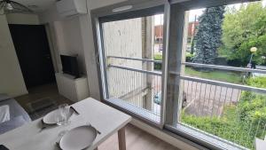 a room with a table and a window with a view at Studio moderne Climatisé Meylan centre proche CHU in Meylan
