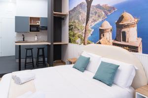 a bedroom with a large white bed with blue pillows at Salerno Stay in Salerno