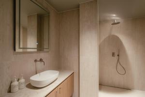 a bathroom with a sink and a shower at Elements Terschelling by Dutchen in Midsland
