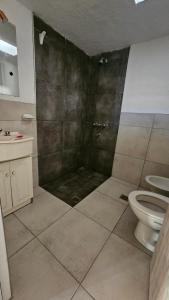 a bathroom with a shower with a toilet and a sink at Bell Ville in Bell Ville