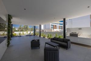 a living room with a couch and chairs in a building at Aqua Pearl Villas in Protaras