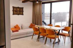 a living room with a couch and a table and chairs at Liso Prostir in Lisopotik