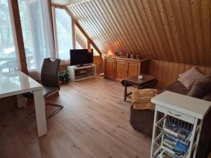 a living room with a couch and a tv at Ferienwohnung Am Spröckel in Bleckede