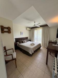 a bedroom with a bed and a chair in it at Villa Ostende Apart Hotel & Spa in Ostende +14 photos