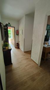an empty room with a hallway with a wooden floor at Villa Lorelia in La Adrada