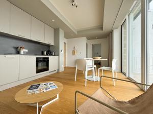 a kitchen and dining room with a table and chairs at Coasteres T2 in Trébeurden