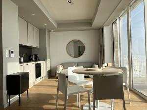 a kitchen and dining room with a table and chairs at Coasteres T2 in Trébeurden +7 photos