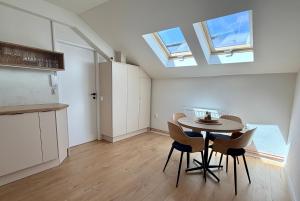 a kitchen and dining room with a table and chairs at Apartmán Štúr Trenčín Centrum in Trenčín