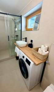 a bathroom with a toilet and a sink and a shower at Apartmán Štúr Trenčín Centrum in Trenčín +17 photos
