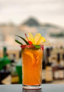 a drink with a yellow flower in a vase at The Athenian Callirhoe in Athens