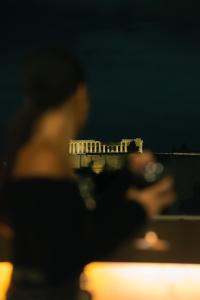 a blurry photo of a person looking at the scen at The Athenian Callirhoe in Athens