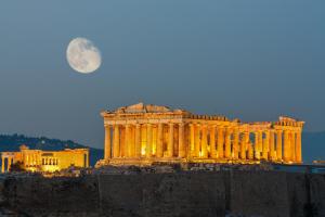 a large building with a full moon in the sky at The Athenian Callirhoe in Athens