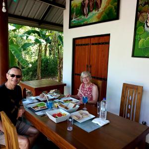 a man and woman sitting at a table with food at Euro Elephant Yala in Tissamaharama