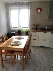 a kitchen with a wooden table and chairs at Casita la 'Dore in Cariño