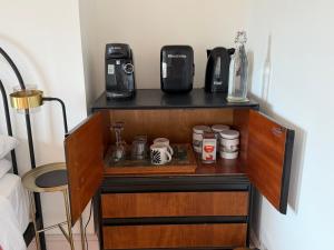 a shelf with a coffee maker and a bottle on it at Charming Town House Central Margate in Margate