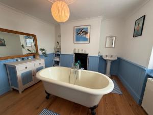 a bathroom with a white tub and a sink at Charming Town House Central Margate in Margate