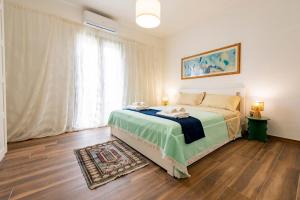 a bedroom with a bed and a large window at GuestHost - Barni House in Montesilvano
