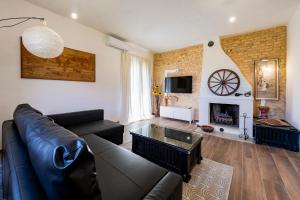 a living room with a couch and a fireplace at GuestHost - Barni House in Montesilvano